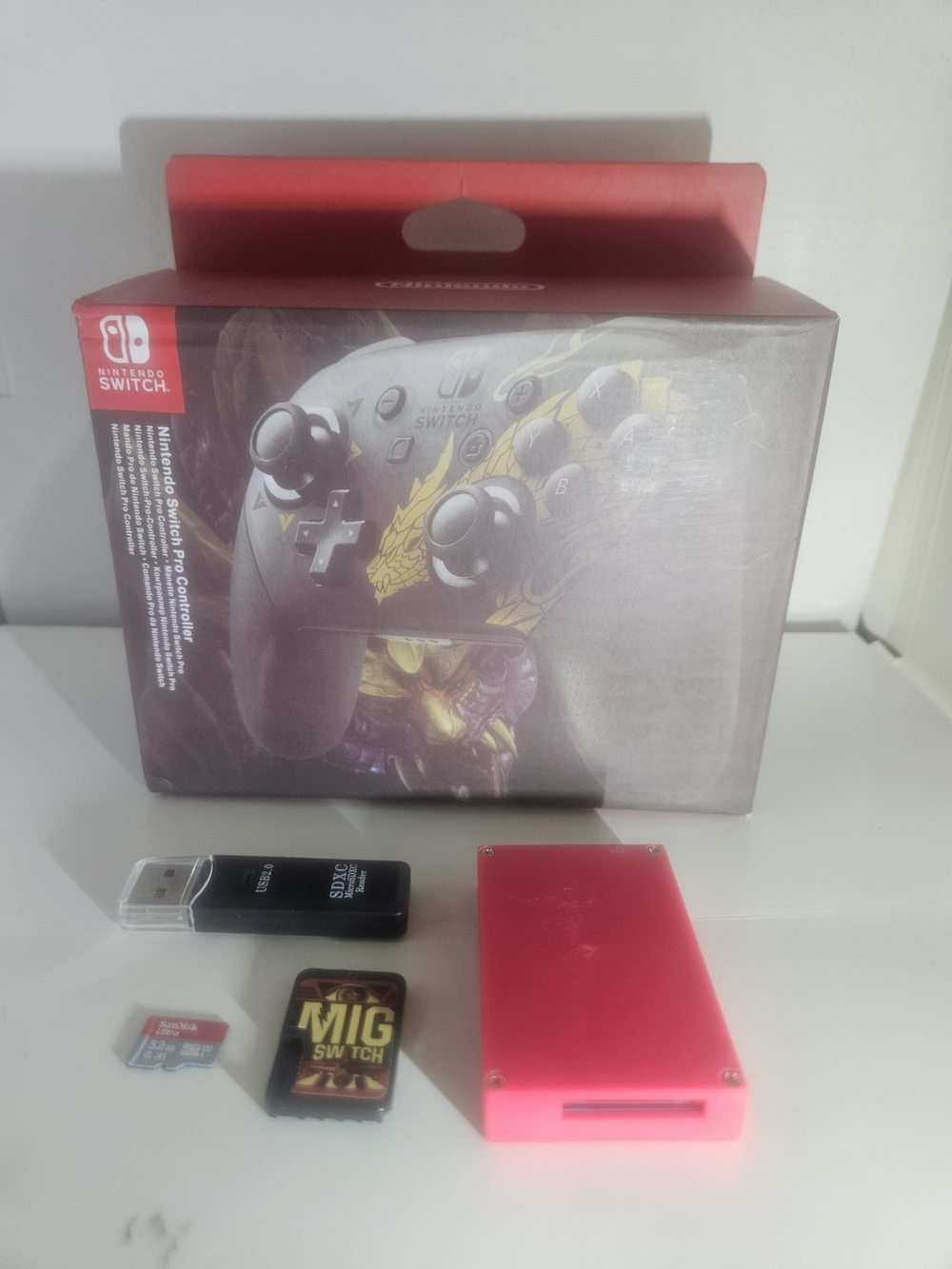 Nintendo Switch Pro Controller Box with Red Accessory and Game Cards
